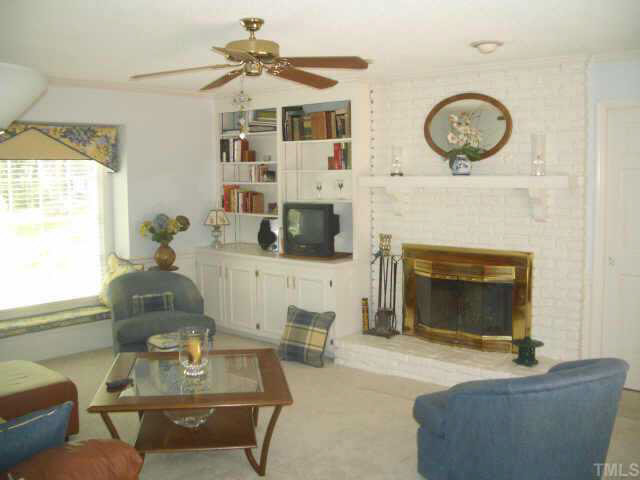 2721 Salisbury Raleigh, NC 27613 - Photo 6 of 10 a living room with furniture and a fireplace
