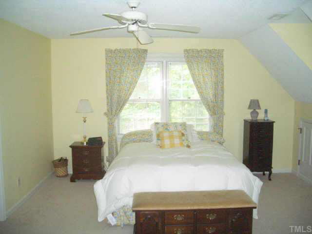 2721 Salisbury Raleigh, NC 27613 - Photo 8 of 10 a bed sitting in a bedroom next to a window
