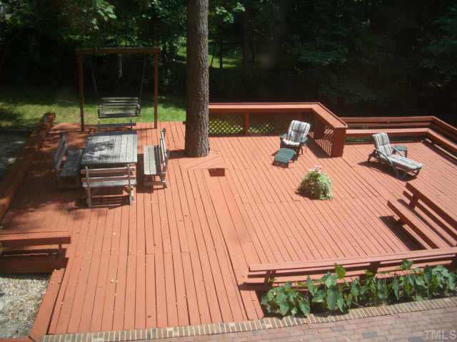 2721 Salisbury Raleigh, NC 27613 - Photo 9 of 10 a view of a patio with table and chairs with wooden floor and fence