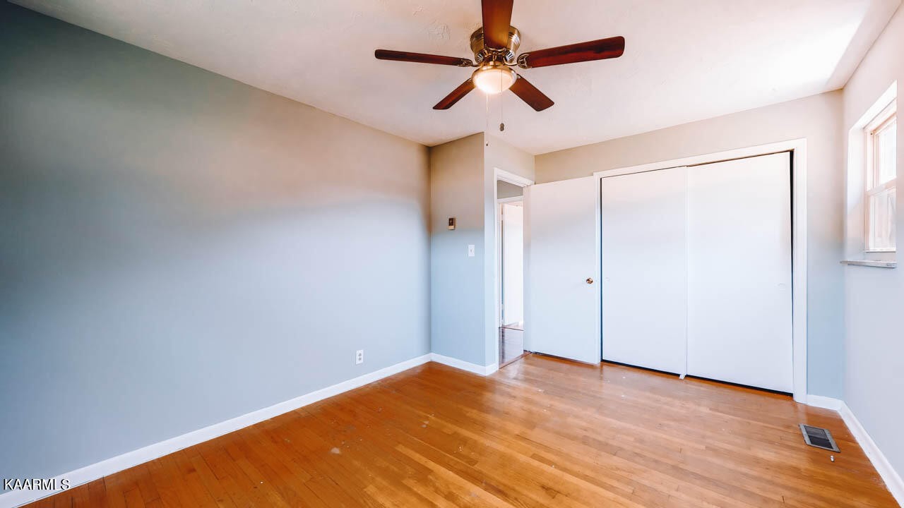 10008 Rutledge Pike Corryton, TN 37721 - Photo 17 of 30 a view of a big room with wooden floor and a ceiling fan