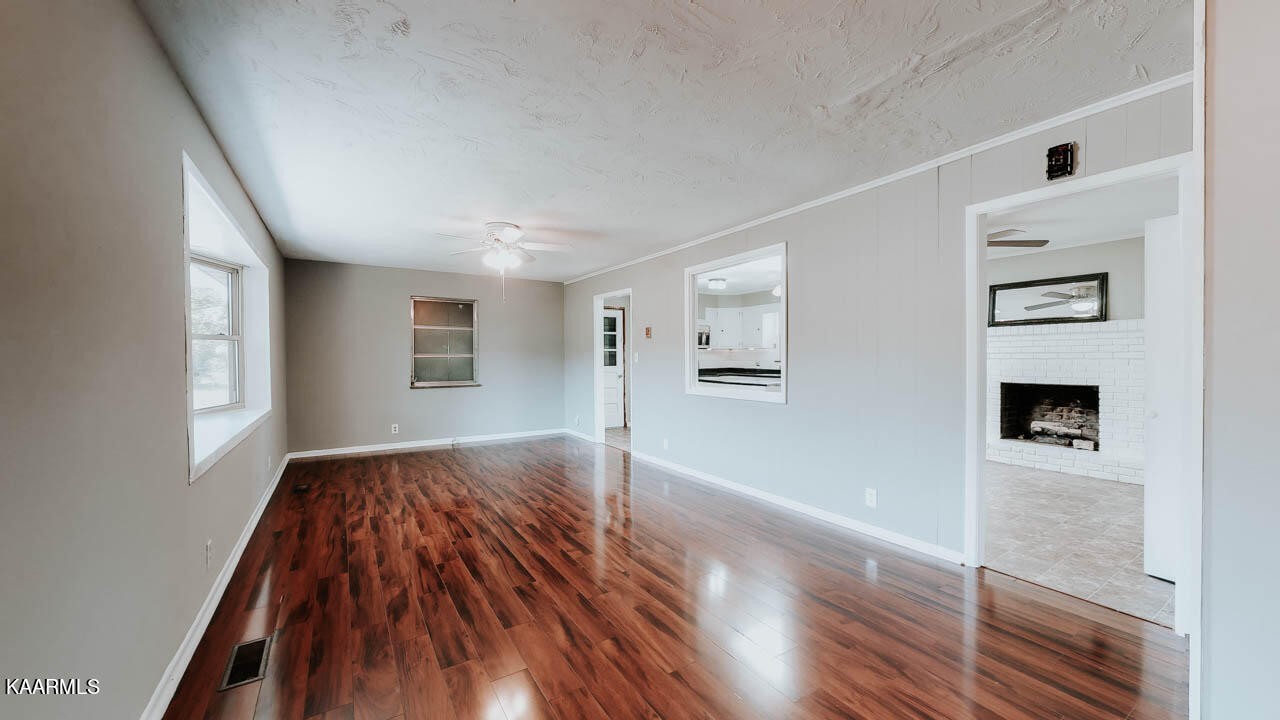 10008 Rutledge Pike Corryton, TN 37721 - Photo 6 of 30 a view of livingroom with hardwood floor and a ceiling fan