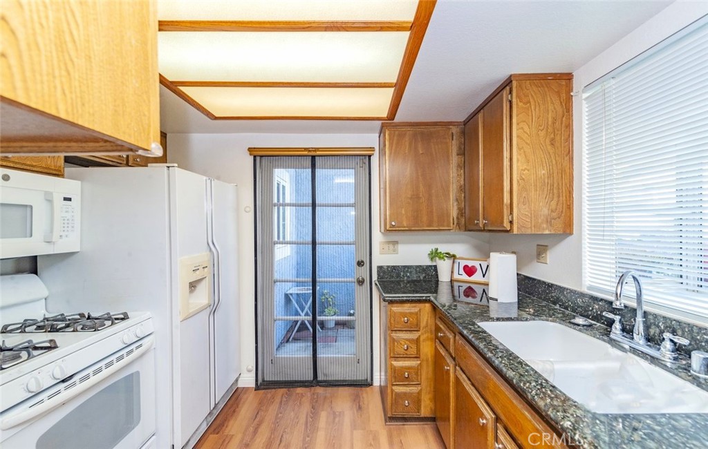 1182 North Sunflower Avenue Covina, CA 91724 - Photo 8 of 20 a kitchen with stainless steel appliances granite countertop a sink stove and refrigerator