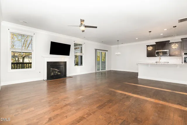 a view of a kitchen with wooden floor and a ceiling fan
