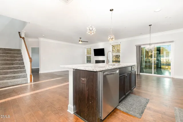 a kitchen with a sink a refrigerator and a stove