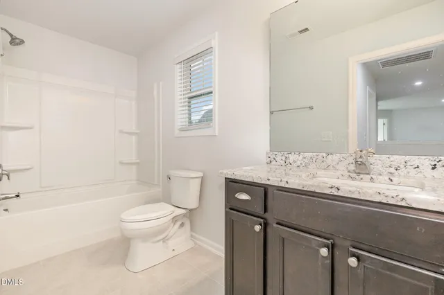 a view of a livingroom with a chandelier fan and wooden floor