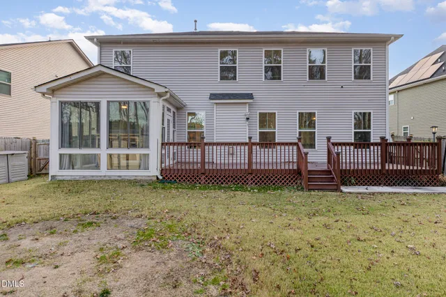 a view of a deck with wooden floor and fence