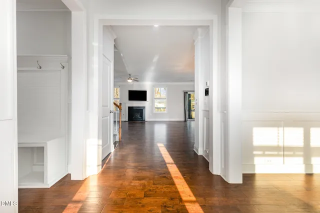 a view of an empty room with wooden floor