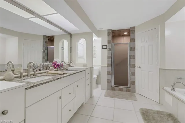 a bathroom with a granite countertop sink mirror and shower