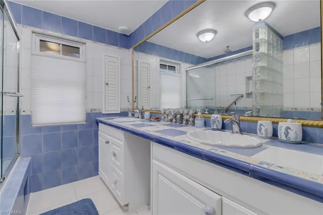 a bathroom with a double vanity sink and a mirror