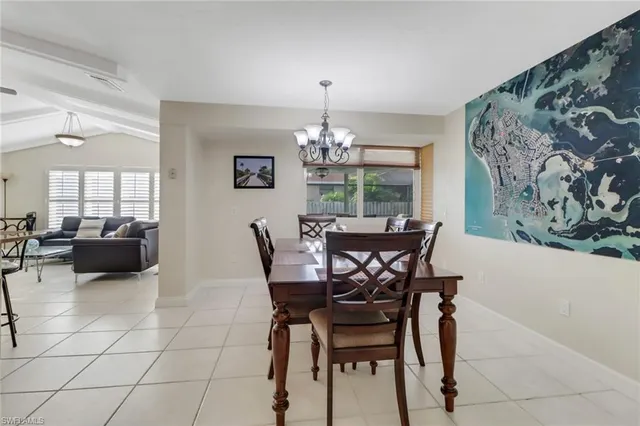 a dining room with furniture and a chandelier