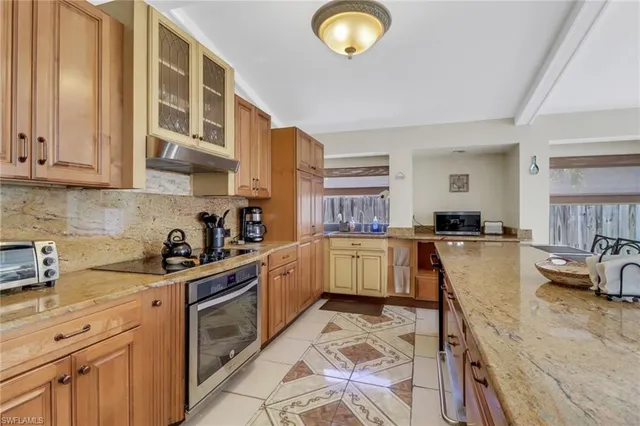 a kitchen with a sink stove and cabinets