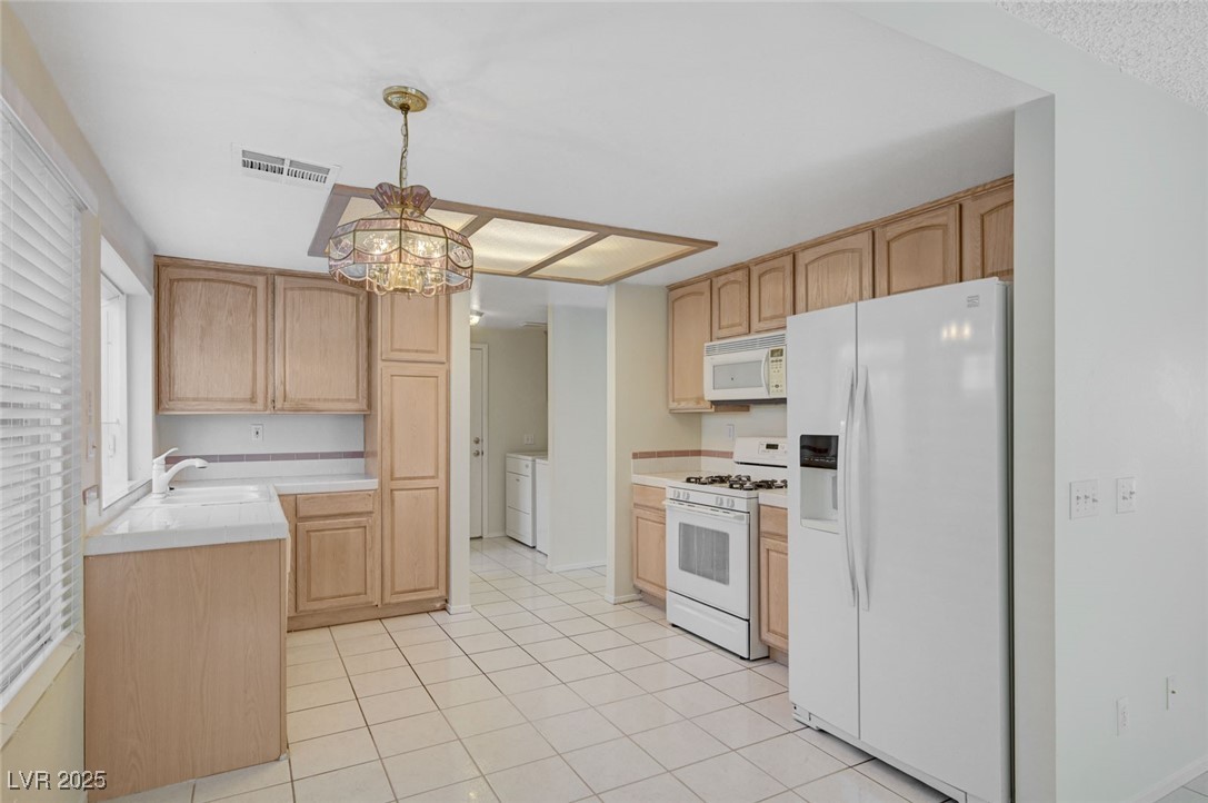 3213 Shallow Point Circle Las Vegas, NV 89117 - Photo 12 of 43 Kitchen with tile countertops and all appliances, tile flooring