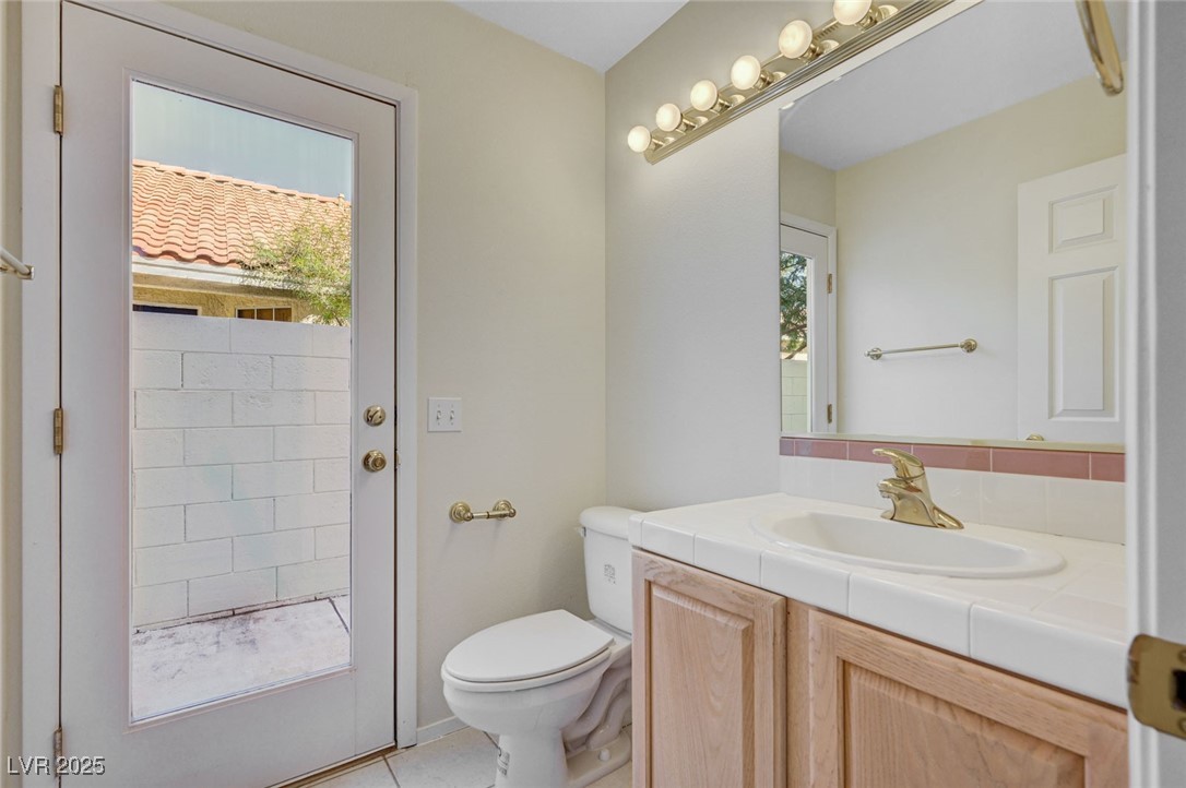 3213 Shallow Point Circle Las Vegas, NV 89117 - Photo 15 of 43 1/2 Bathroom downstairs with access door to backyard