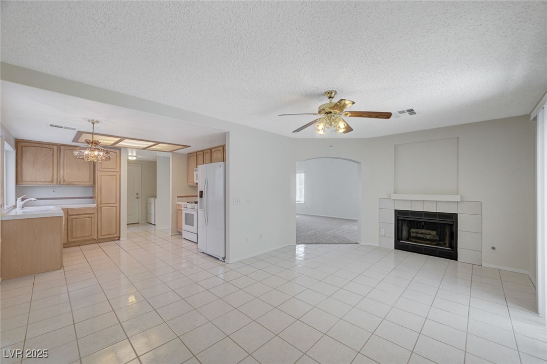 3213 Shallow Point Circle Las Vegas, NV 89117 - Photo 9 of 43 Family room showing gas fireplace and tile flooring