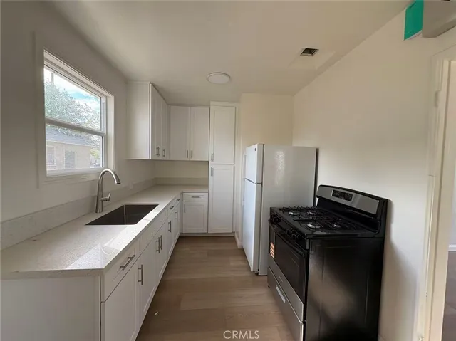 a kitchen that has a sink and a stove