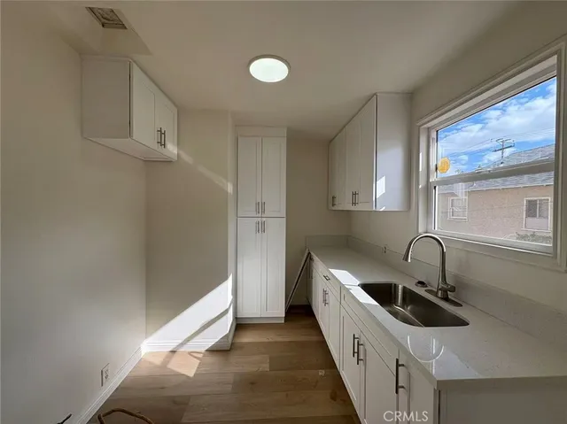 a kitchen with stainless steel appliances a sink and a refrigerator