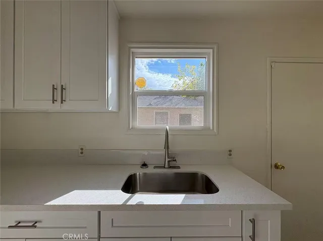 a view of a sink and cabinets
