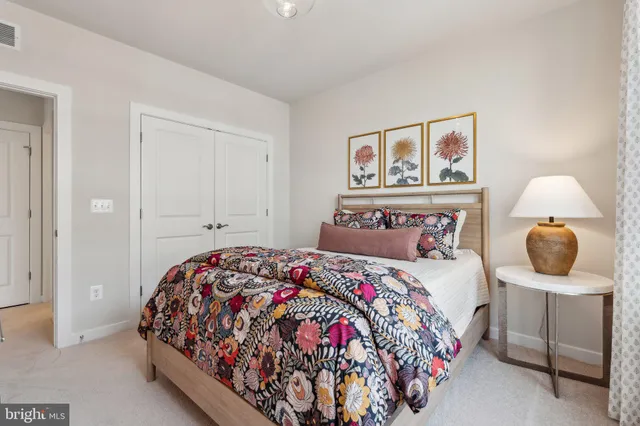 a bedroom with a bed and painting on the wall