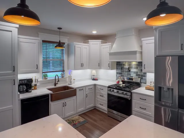a kitchen with stainless steel appliances a sink dishwasher stove and refrigerator