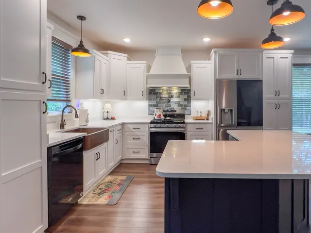 a kitchen with a sink a stove a refrigerator and cabinets