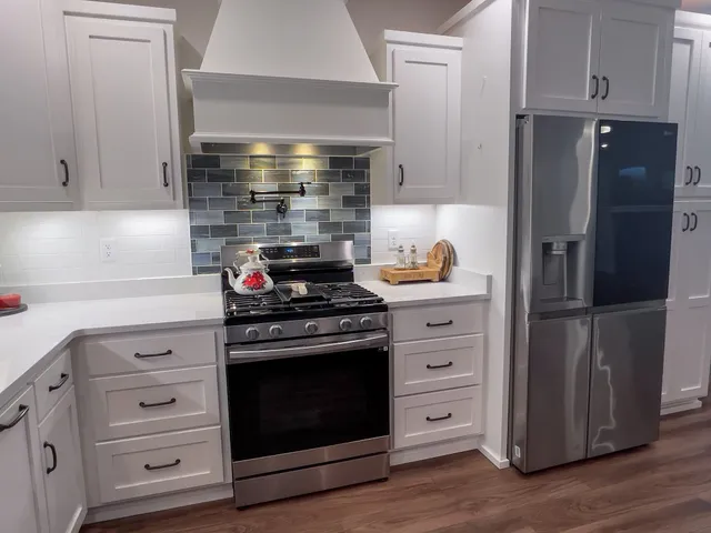 a kitchen with stainless steel appliances white cabinets and a stove