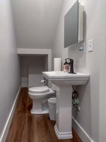 a bathroom with a sink toilet and a mirror