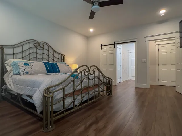 a bedroom with a bed and wooden floor