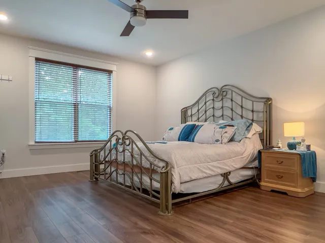 a bedroom with a bed and a window