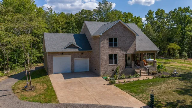 a aerial view of a house with table and chairs in patio