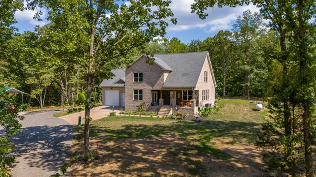 a view of a house with patio and a yard