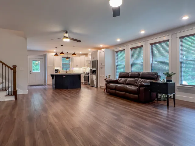 a living room with furniture and a wooden floor