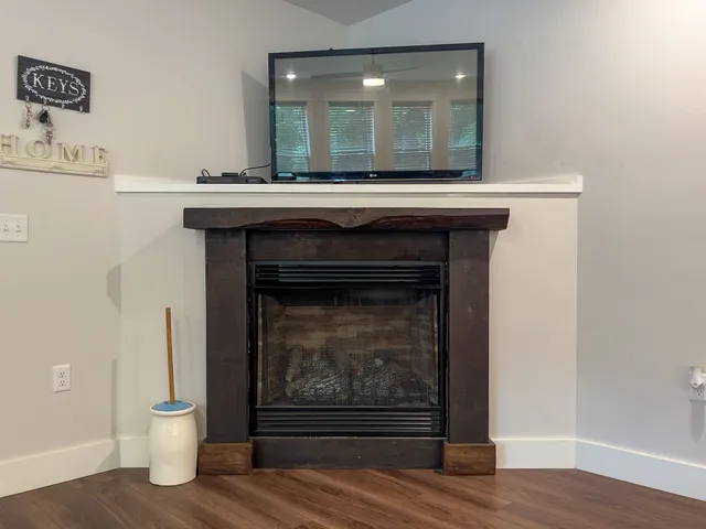 a room with a fireplace and wooden floor