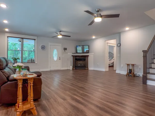 a living room with furniture and wooden floor