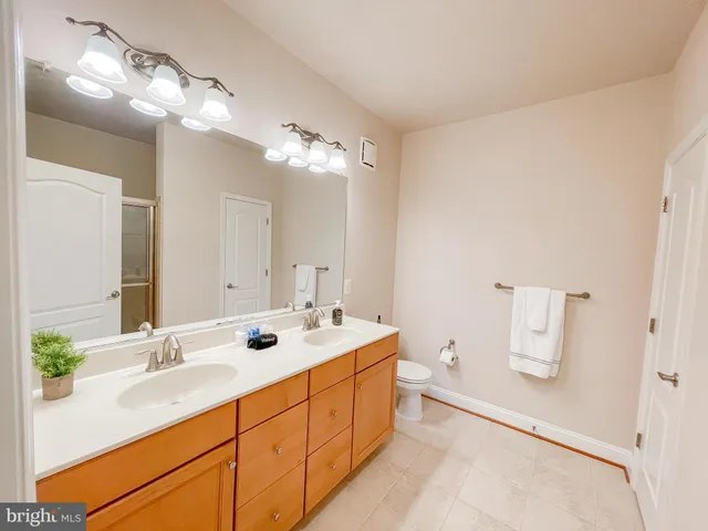 a bathroom with a double vanity sink mirror and vanity
