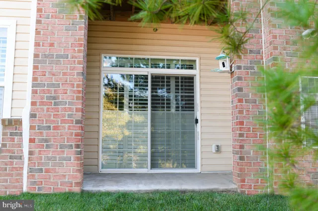 a view of front door of house with green space