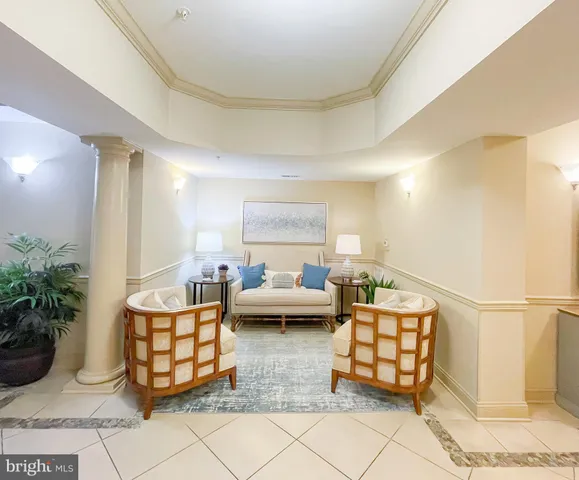 a living room with a chair and a potted plant
