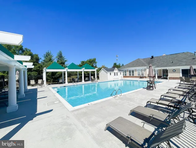 a large kitchen with stainless steel appliances lots of counter space and a sink