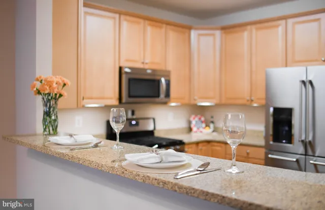 a bathroom with a granite countertop sink a large mirror and a window