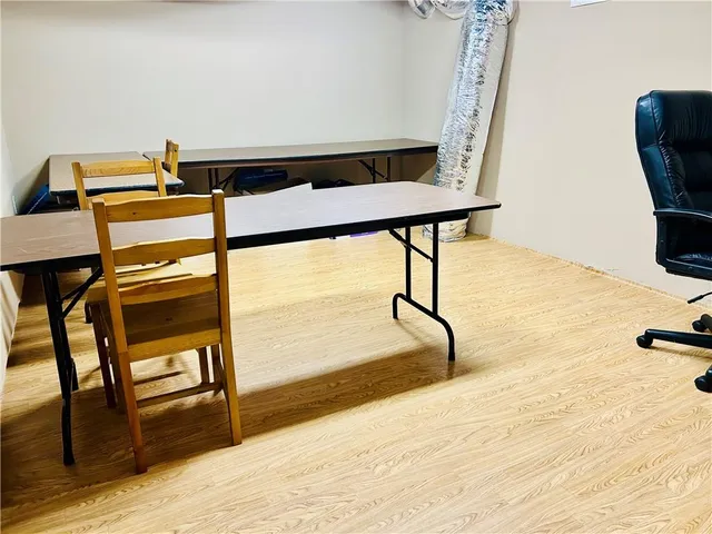 a view of a room with wooden floor