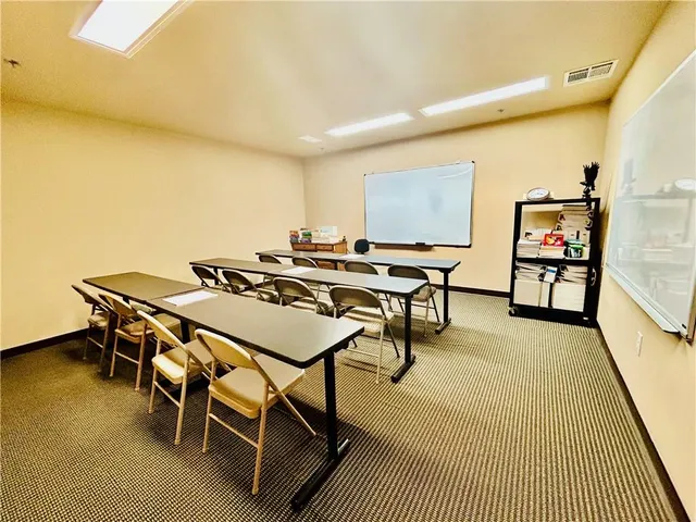 a view of a room with furniture and wooden floor