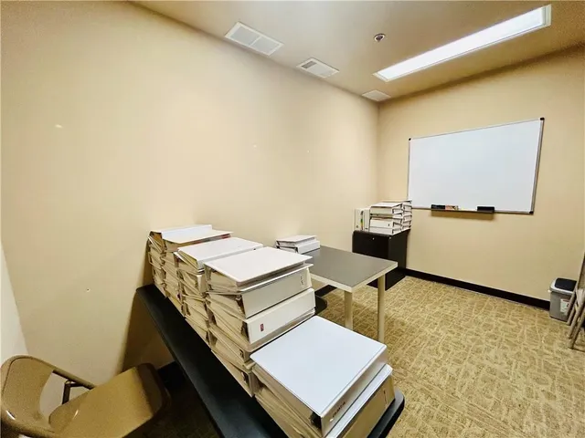 a reading room with furniture and rug