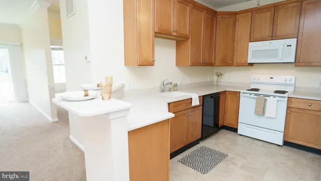 a kitchen with stainless steel appliances granite countertop a sink a stove and dishwasher