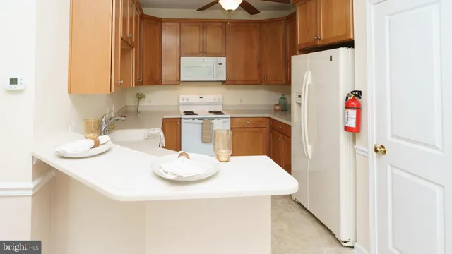 a kitchen with stainless steel appliances a refrigerator and a stove