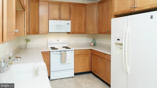 a kitchen with a sink a stove and cabinets
