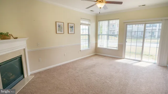 a view of an empty room with a fireplace and a window