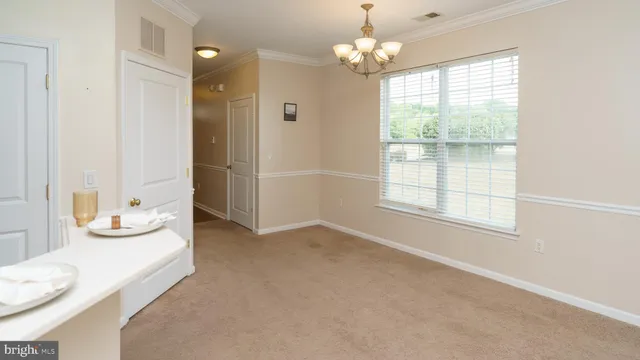 a spacious bedroom with a bed and a chandelier
