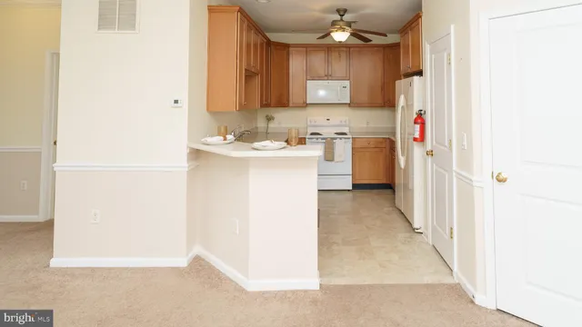 a kitchen with kitchen island a sink a stove and refrigerator