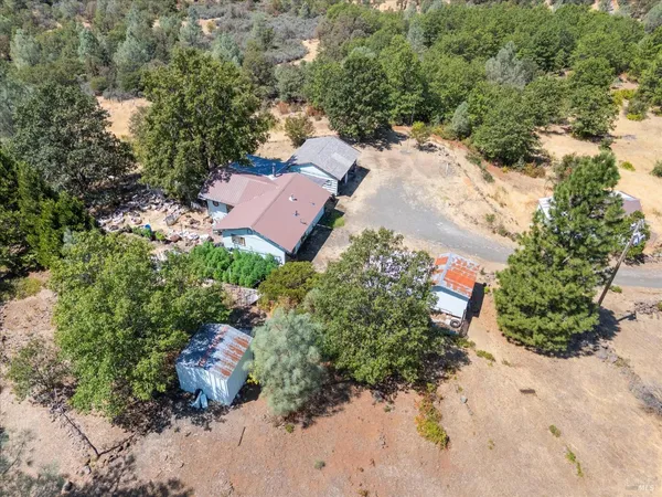 an aerial view of a house with a yard