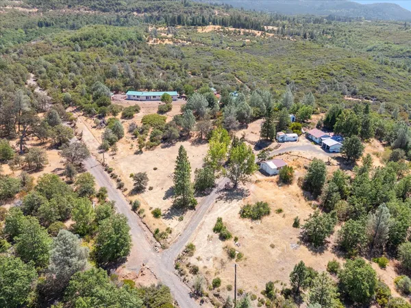 an aerial view of house with yard and swimming pool