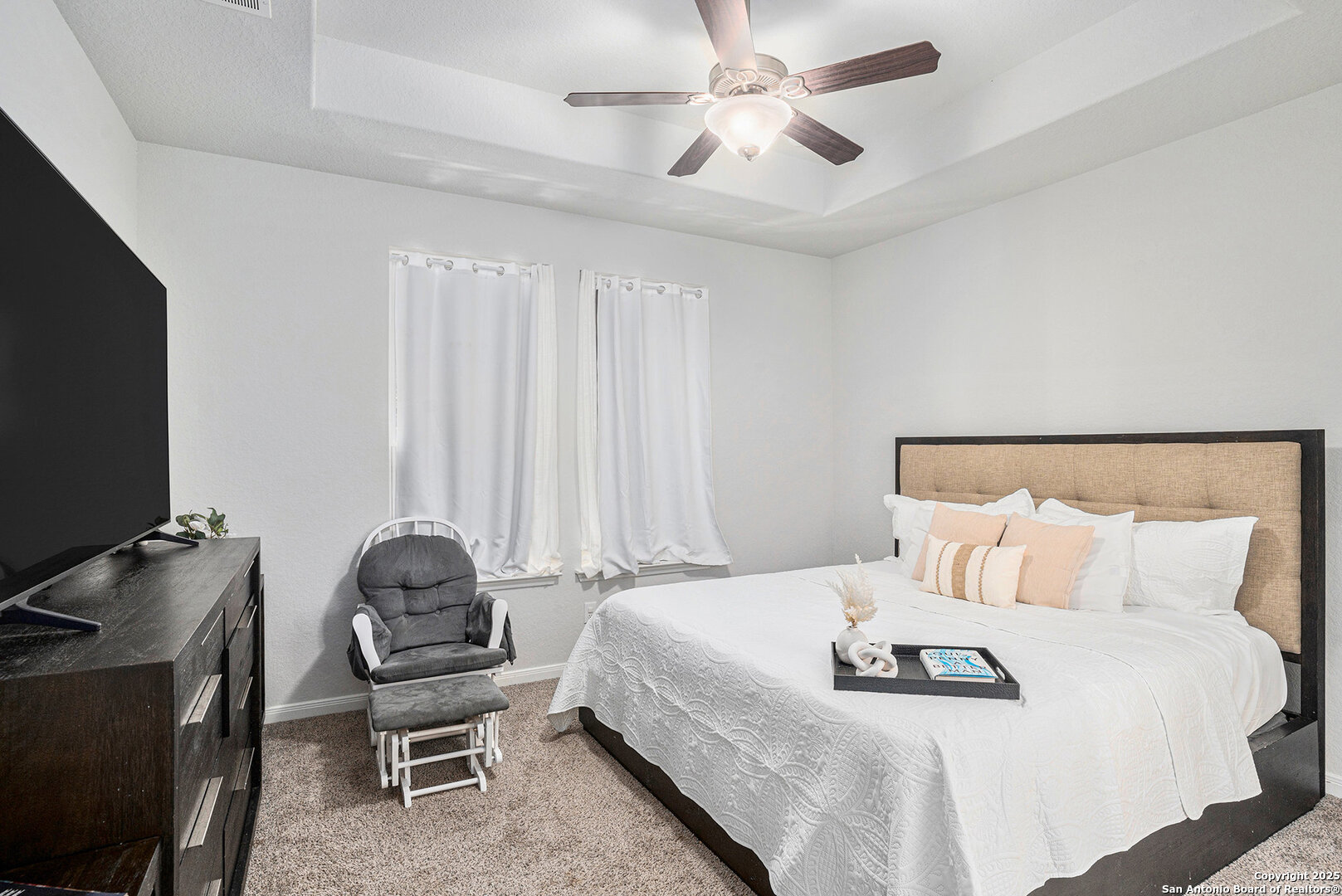 16615 Ginger Crossing Elmendorf, TX 78112 - Photo 11 of 31 a bedroom with a bed and a flat screen tv